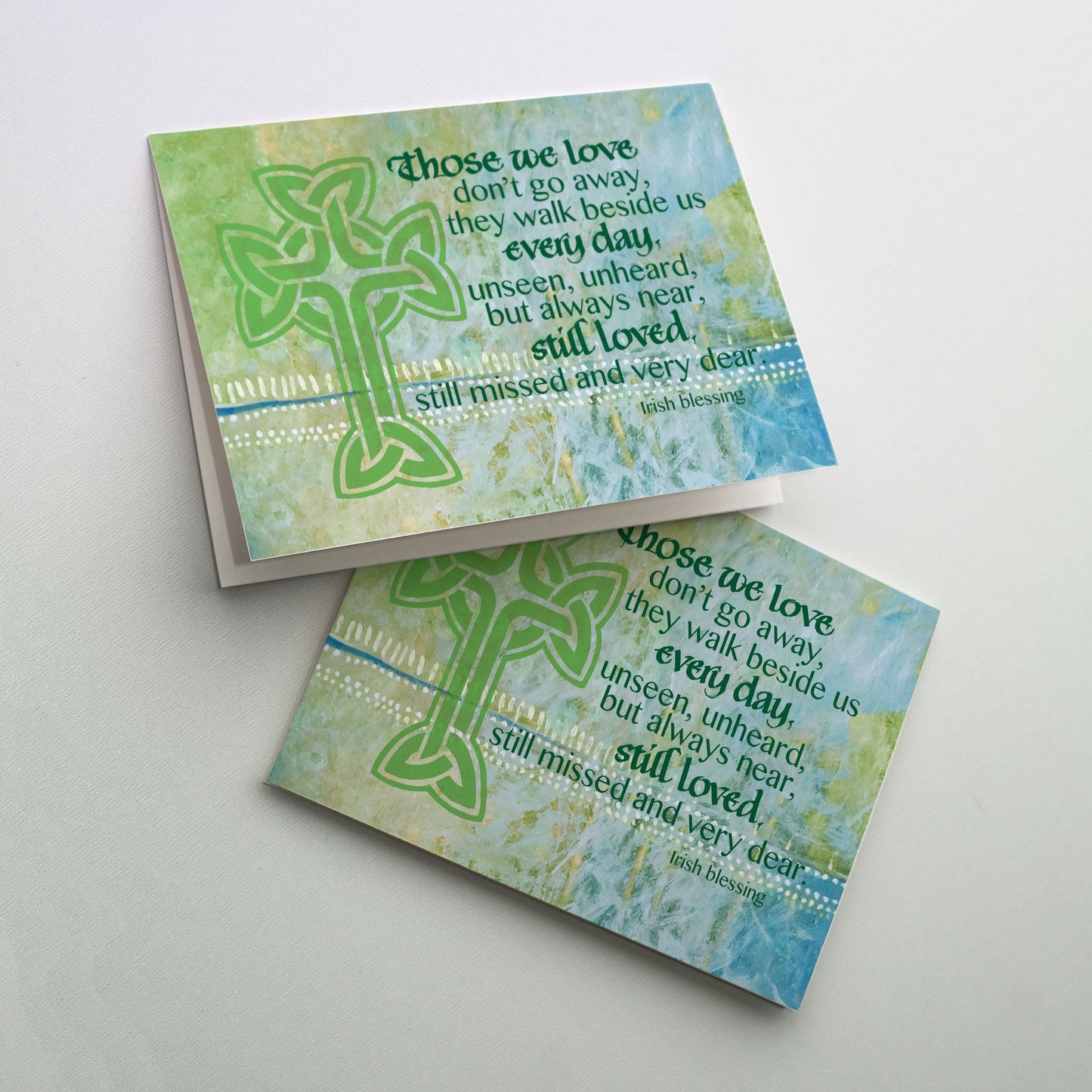 Green Celtic cross on soft green-blue background