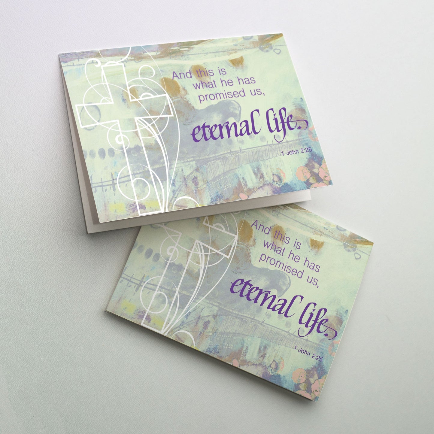 White filigree cross with calligraphy on softly painted background