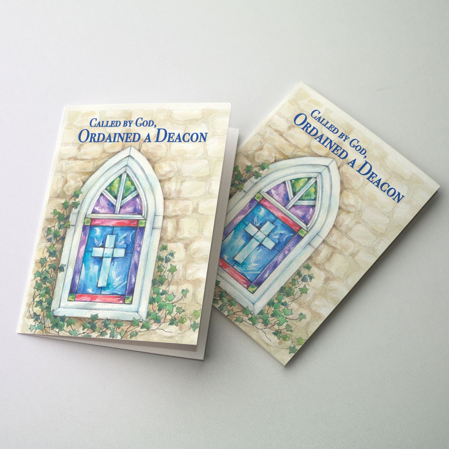 Watercolor image of a stone church with a stained glass window featuring a cross