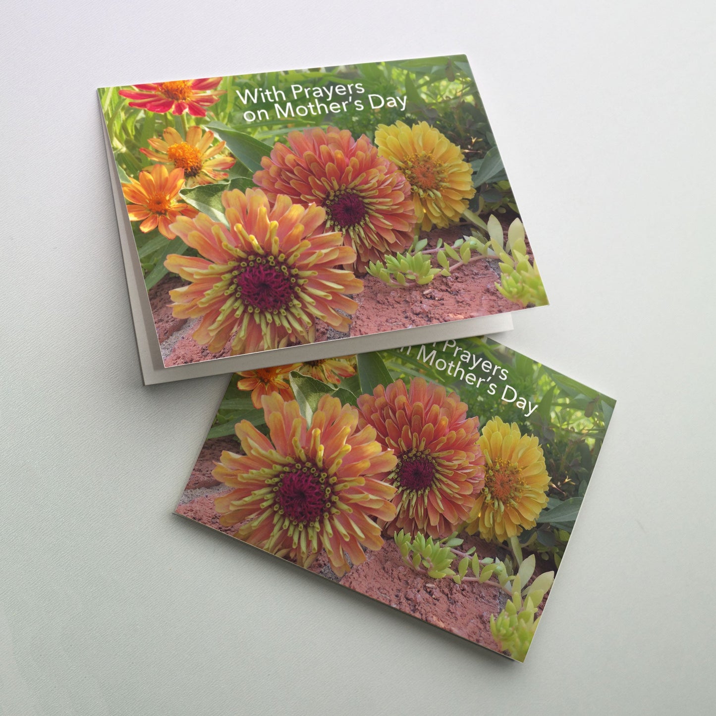 Do you know someone whose mother passed away? Mother’s Day for those who are still grieving can bring sadness and pain. You can offer comfort and peace by praying for them and sending them hope in the form of a Mother’s Day card that addresses this difficult time. Your thoughtfulness can serve as a caring reminder of the peace they can find in God’s love and promise of eternal life.<br> <br> Cover art: photo of warm-colored zinnias lying softly in the shade of a sunny day.