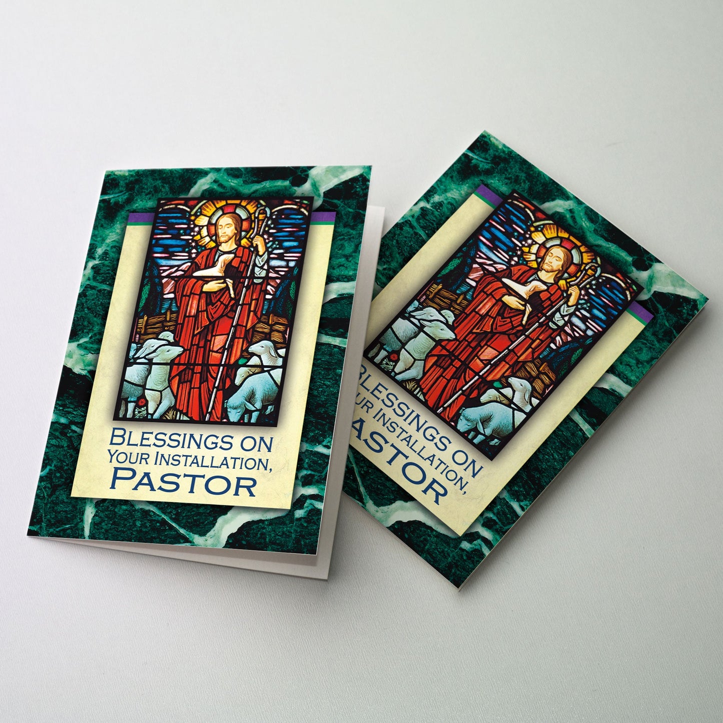 Stained glass image of Jesus the Good Shepherd bordered with green malachite stone.