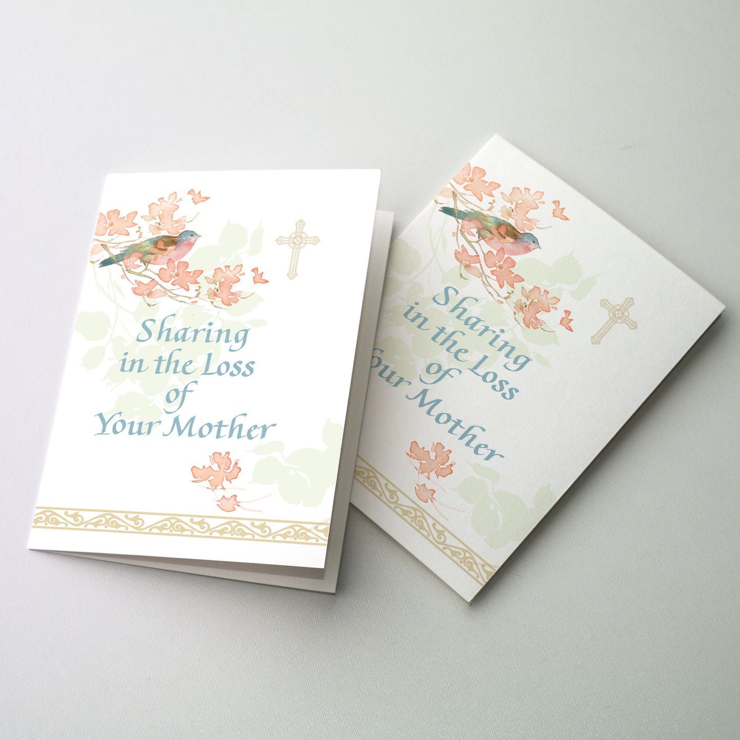 Gentle watercolor painting of a bluebird in a blooming dogwood tree with soft gold metallic cross and trim