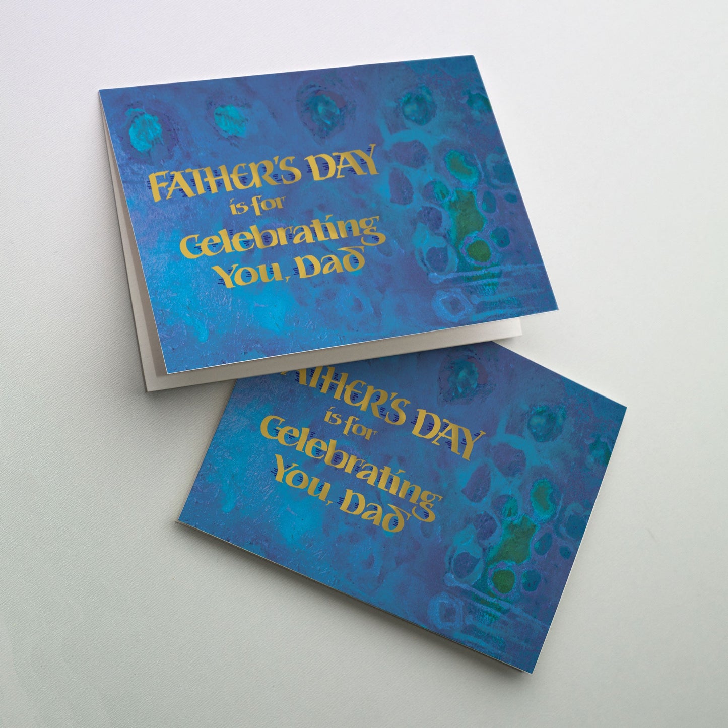 Gold metallic calligraphy on rich blue and green painted background