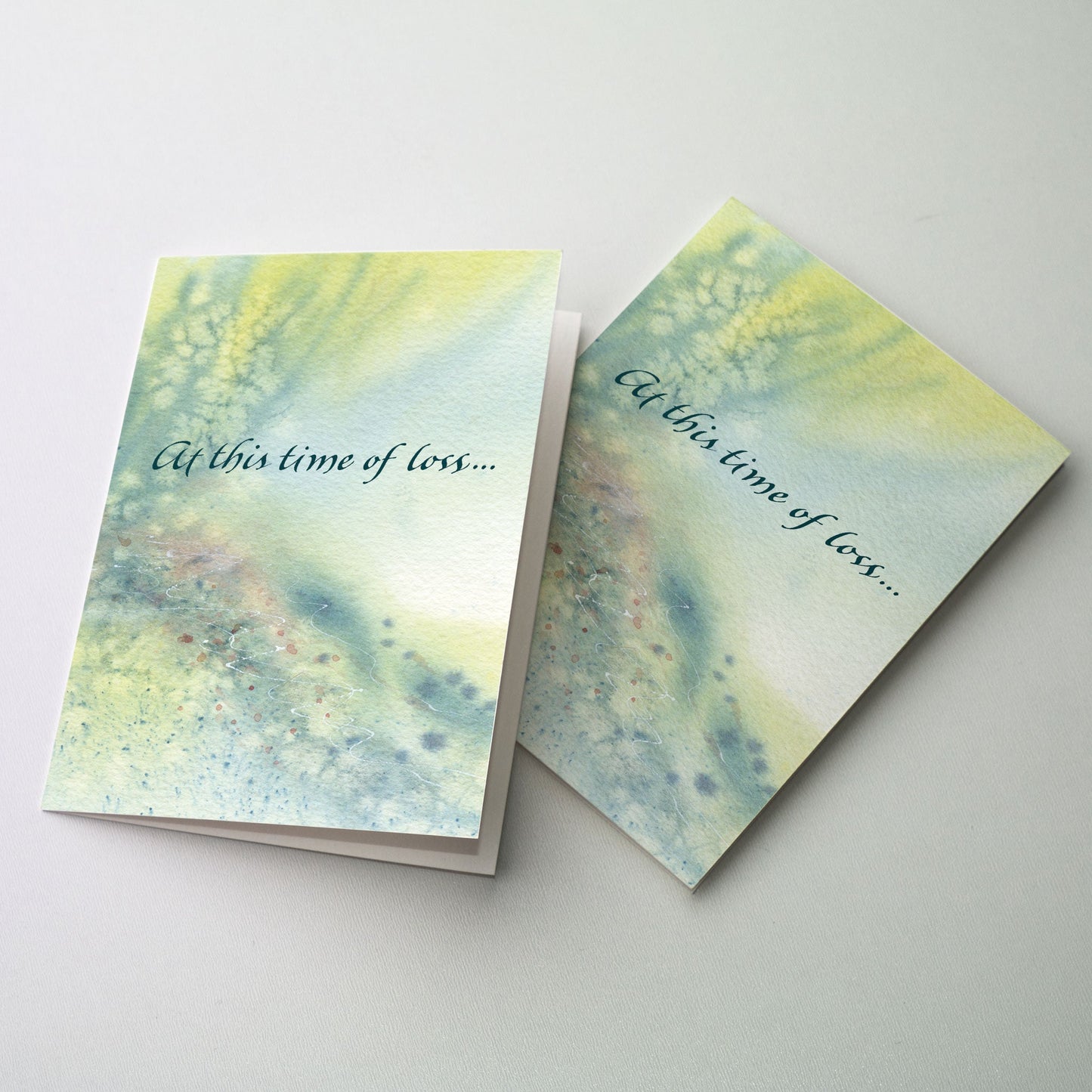 Abstract watercolor of a yellow and green wedge shaped border at the left which opens to brighter color at the right.