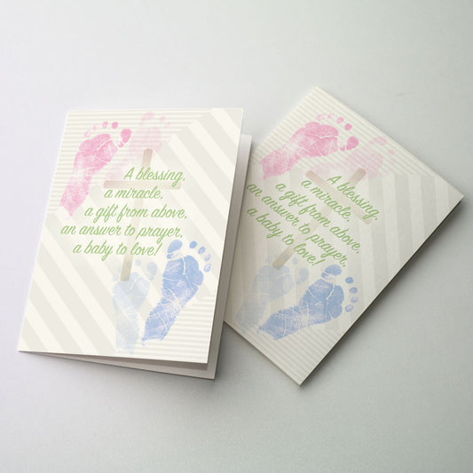 Baby foot prints, one pink and one blue with a cross in the center