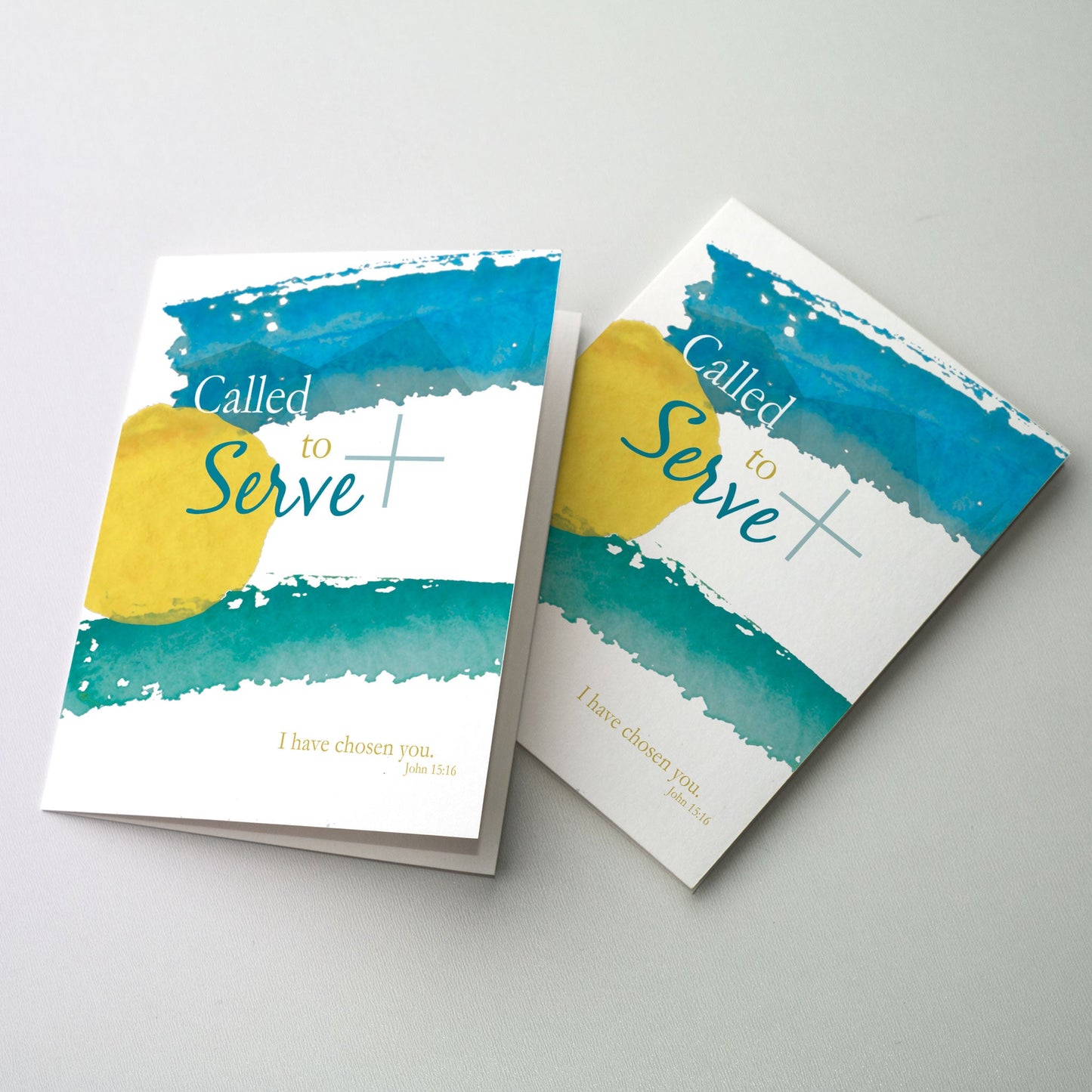 Blue, yellow, and green paint strokes with a green cross and colored lettering