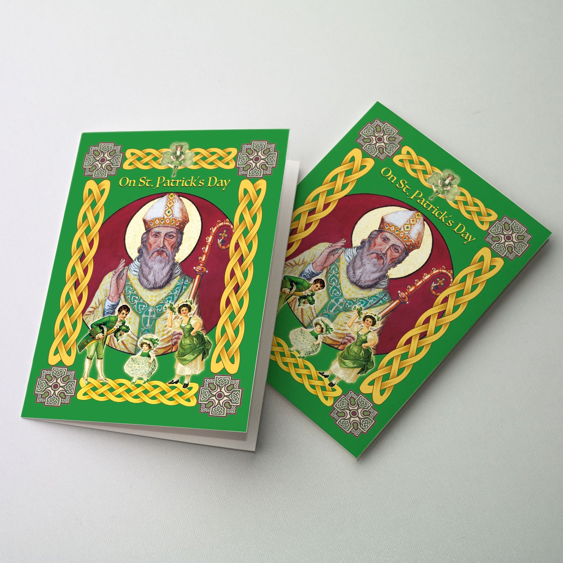 The centerpiece is a mural of St. Patrick from the Abbey Basilica with his hand in blessing while three figures dance in the foreground; a Celtic border with golden knotwork and a cross in each corner surrounds the cover.