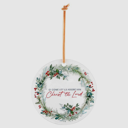 Decorative Christmas ornament with wreath design and text on a white background